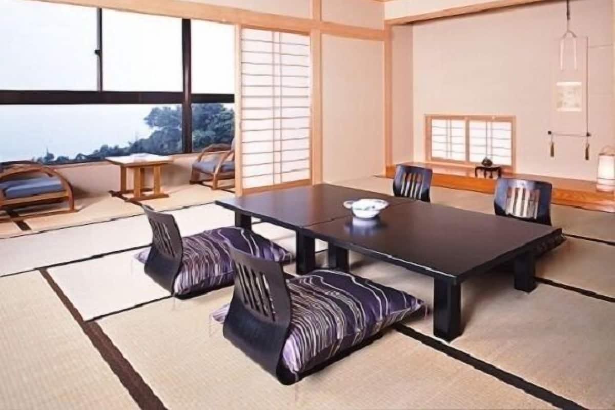 A traditional Japanese-style room with tatami flooring, a low table, and shoji screens.