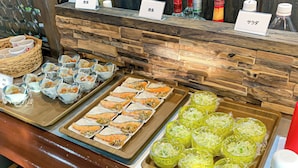 A buffet with various dishes, including seafood and vegetables, and a selection of beverages. - Business Hotel Nishine (Hachimantai)