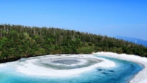 A natural ice formation surrounded by a forest. - Business Hotel Nishine (Hachimantai)