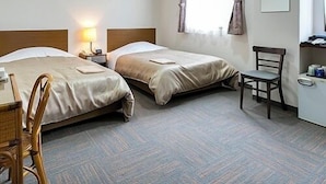 A hotel room with two beds, a desk, a chair, a lamp, and a window with curtains. - Business Hotel Nishine (Hachimantai)