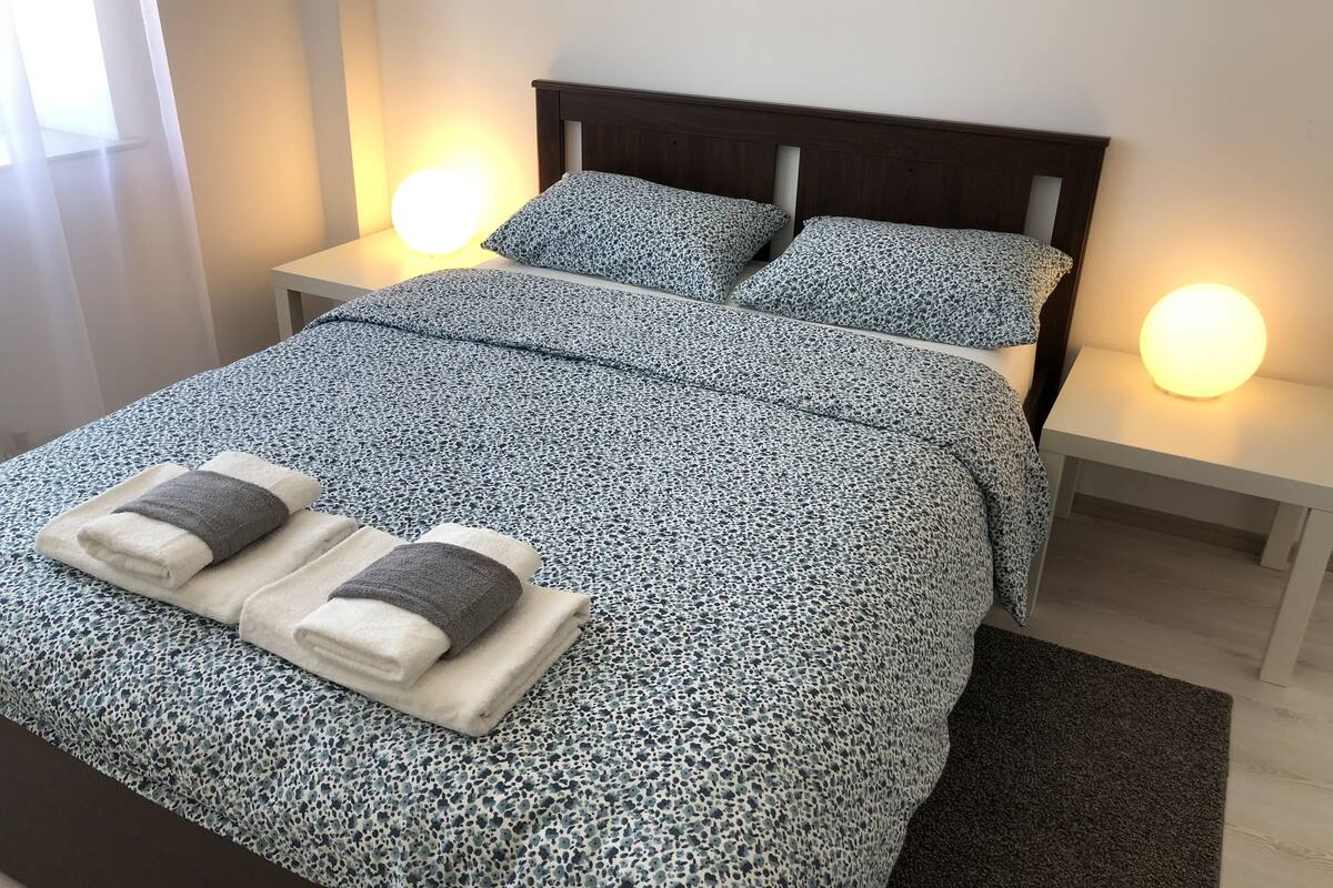 Hypo-allergenic bedding, desk, laptop workspace, blackout curtains