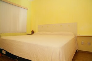 Enjoy a restful stay in this cozy room with a single bed, nightstand, and window with blinds.