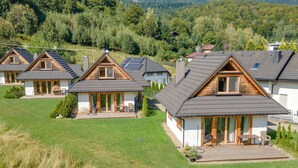 A row of modern houses with sloped roofs, wooden decks, and large windows. - Chaty Pod Beskidkiem by Interhome (Szczyrk)