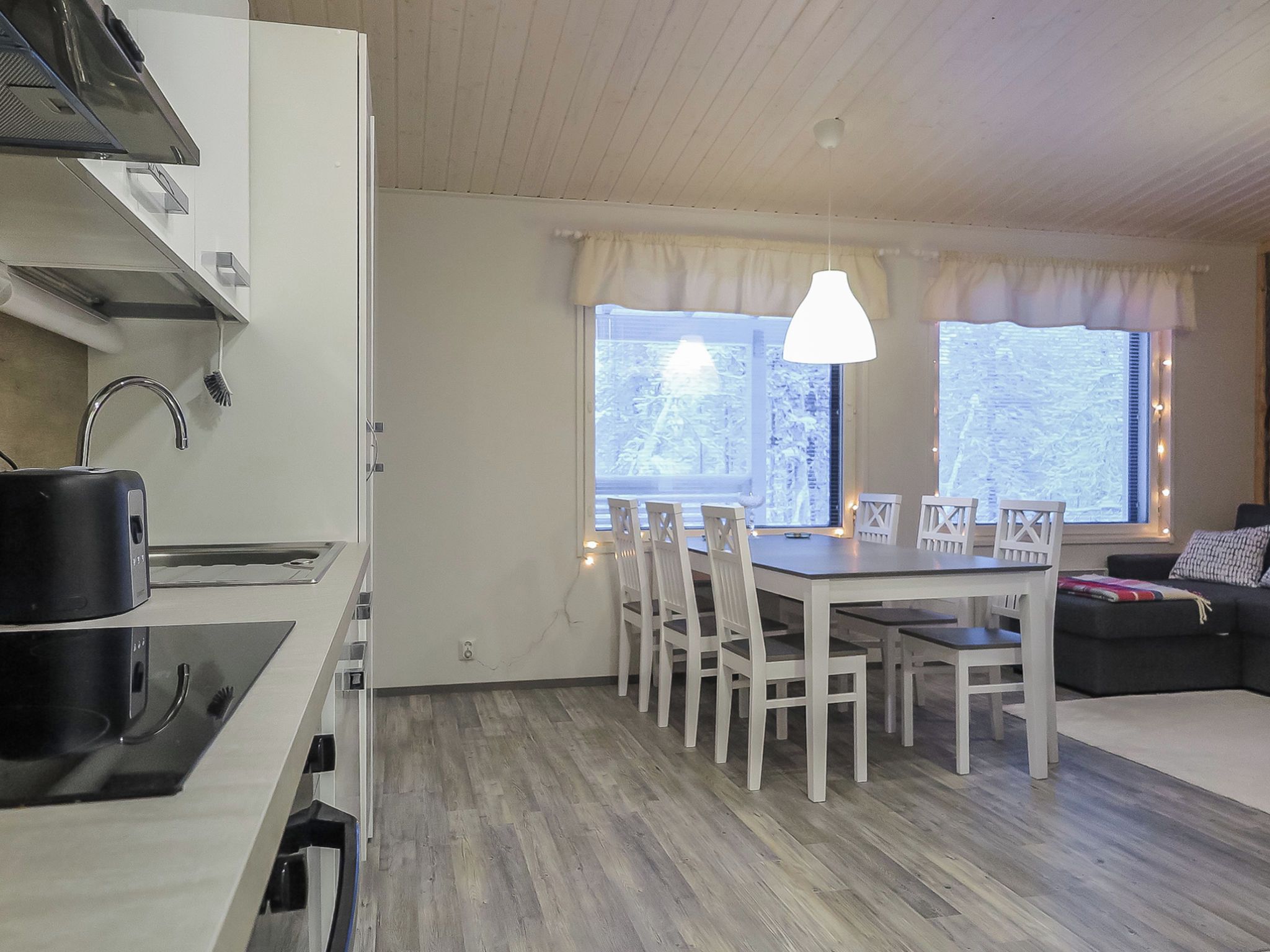 A compact living space with a kitchenette, dining area, and seating area.