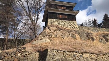 Un edificio japonés tradicional con base de piedra y estructura superior de madera.