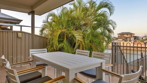 Relax on the patio surrounded by serene views of the water and lush greenery.
