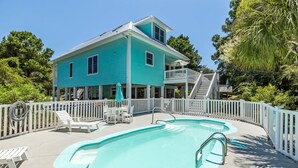 A two-story building with a pool, white railings, and outdoor seating. - Oceanside Interior Home,Private Pool,Golf Cart,Beach Access,in Spinnaker's Reach (Emerald Isle)