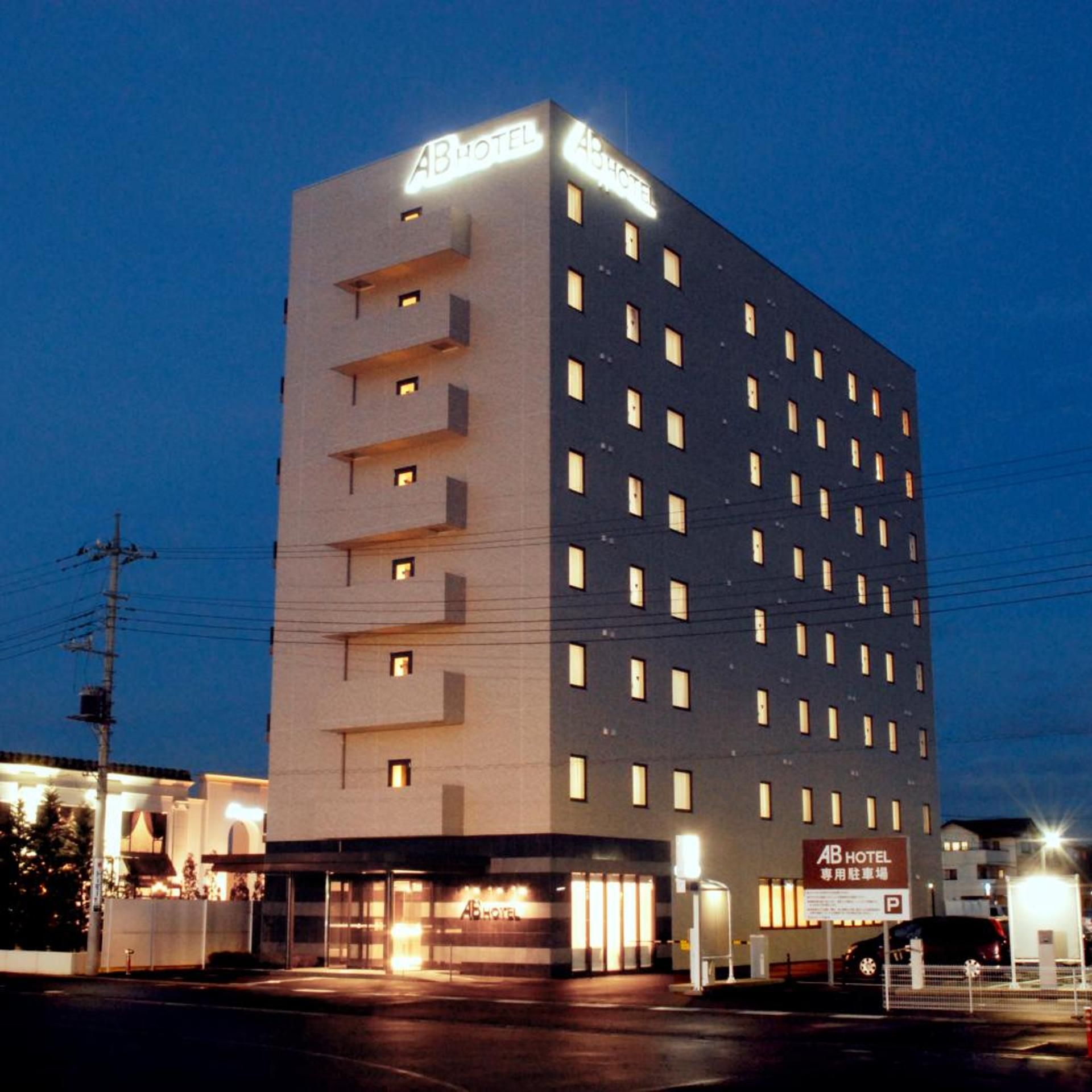 A multi-story hotel with a prominent 'AB HOTEL' sign on the top.