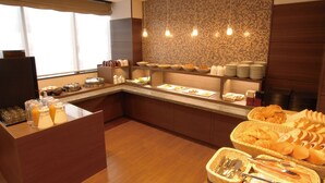 A buffet setup with various food items and utensils. - Ab Hotel Isesaki (Isesaki)
