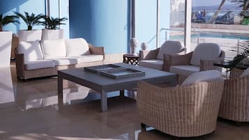 A modern lounge area with a sofa, chairs, and a coffee table.