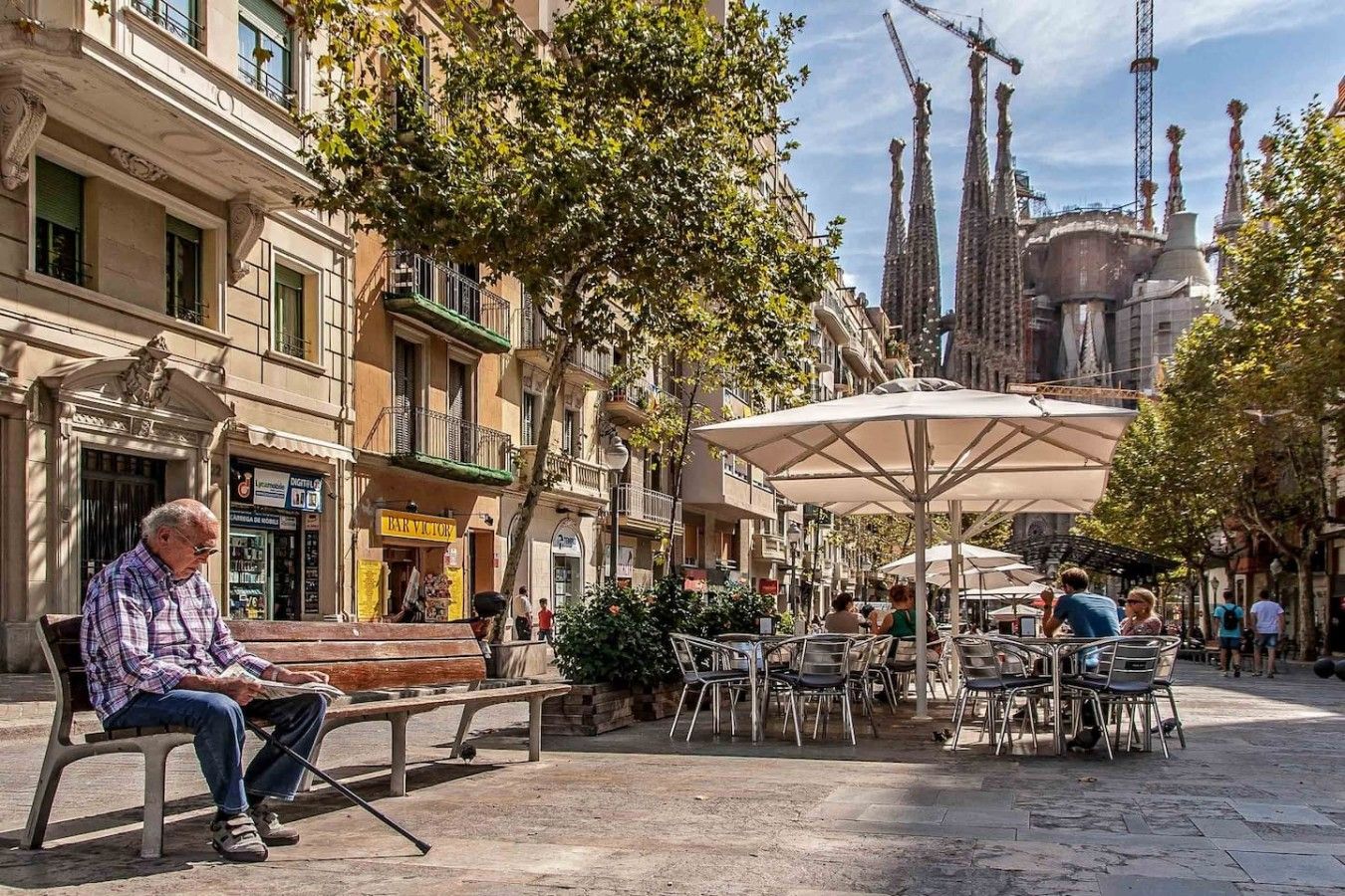 A plaza with outdoor seating, benches, and umbrellas.