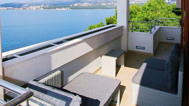 A balcony with a view of a lake and mountains, furnished with a sofa and chairs. - Villa Mustra by Interhome (Trogir/Okrug Donji)