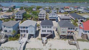 A coastal residential area with houses connected by walkways to the beach. - Family Seaclusion - Oceanfront in Garden City Beach (Garden City Beach)