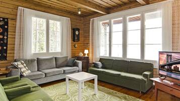 A cozy living room with two sofas, a coffee table, and a television.