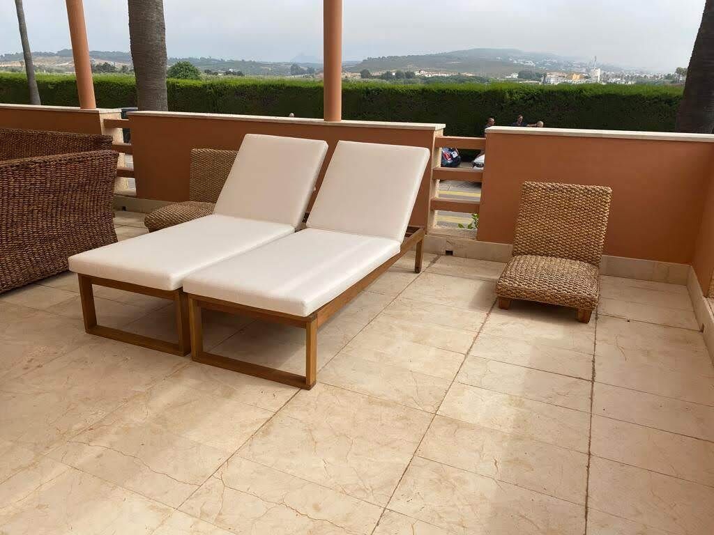 A sun loungers area with a view of the landscape.