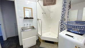 Bathroom features a bathtub, sink, and mirror.