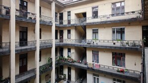 A multi-story building with balconies, staircases, and windows. - Unique and central apartment in a quiet side street (IX. kerület)