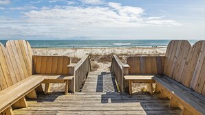 A wooden deck with benches leading to a beach. - Oceanfront duplex with direct beach access (Emerald Isle)