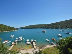 A marina with boats docked, surrounded by hills and clear blue water. - Apartment Ulika by Interhome (Pula/Krnica)