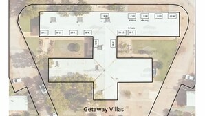 A layout of a vacation property with numbered sections, including private and storage areas, and a central driveway. - Getaway Villas Unit 38-9 - comfort on a budget (EXMOUTH)