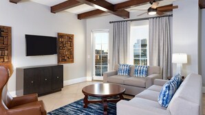 A modern living room with a sofa, armchair, and a coffee table.