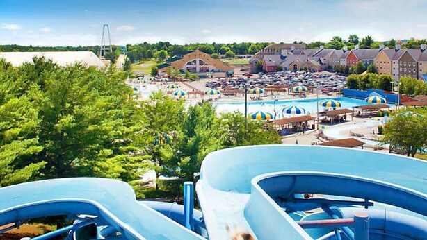 A water park with multiple slides and a swimming pool area.