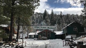 A snow-covered road leading to a building labeled "The Last Resort." - The Last Resort Lodge (New Meadows)