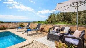 A rooftop pool area with lounge chairs, a table, and an umbrella. - Binicalaf · ❤️Finca Binicalaf Vell (Maó)