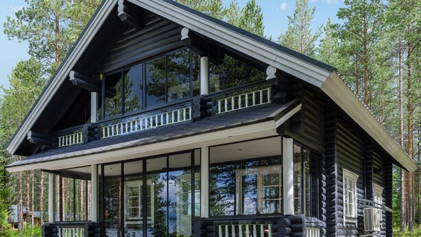 A log cabin with a balcony, large windows, and a porch area. - Hatun huilaus by Interhome (Ilomantsi)