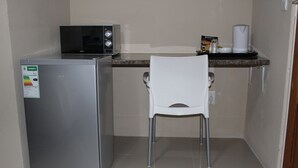 A compact kitchenette with a refrigerator, microwave, and a small countertop. - M n M Guest House in Polokwane Turfloop (Polokwane)