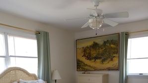 A bedroom with a bed, a dresser, a painting, and a ceiling fan. - NEW LISTING! - Quaint Cape May Beach House Only Blocks to the Beach (North Cape May)