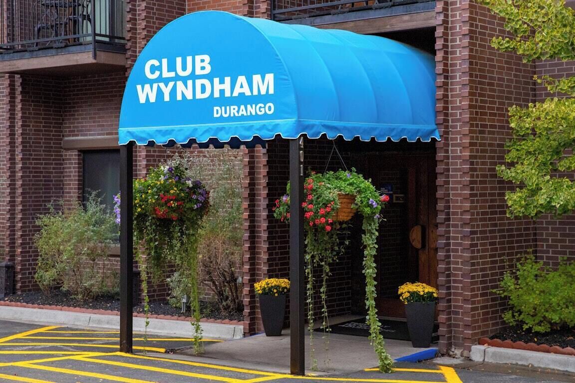 A brick building with a blue awning labeled 'CLUB WYNDHAM DURANGO.'