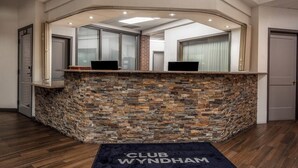 A reception area with a stone counter, two computers, and a sign that reads 'CLUB WYNDHAM.' - MountainSide Resort near Zip Lining and Museums (Durango)