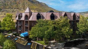 A multi-story building with a unique architectural design, featuring arched windows and a central tower. - MountainSide Resort near Zip Lining and Museums (Durango)
