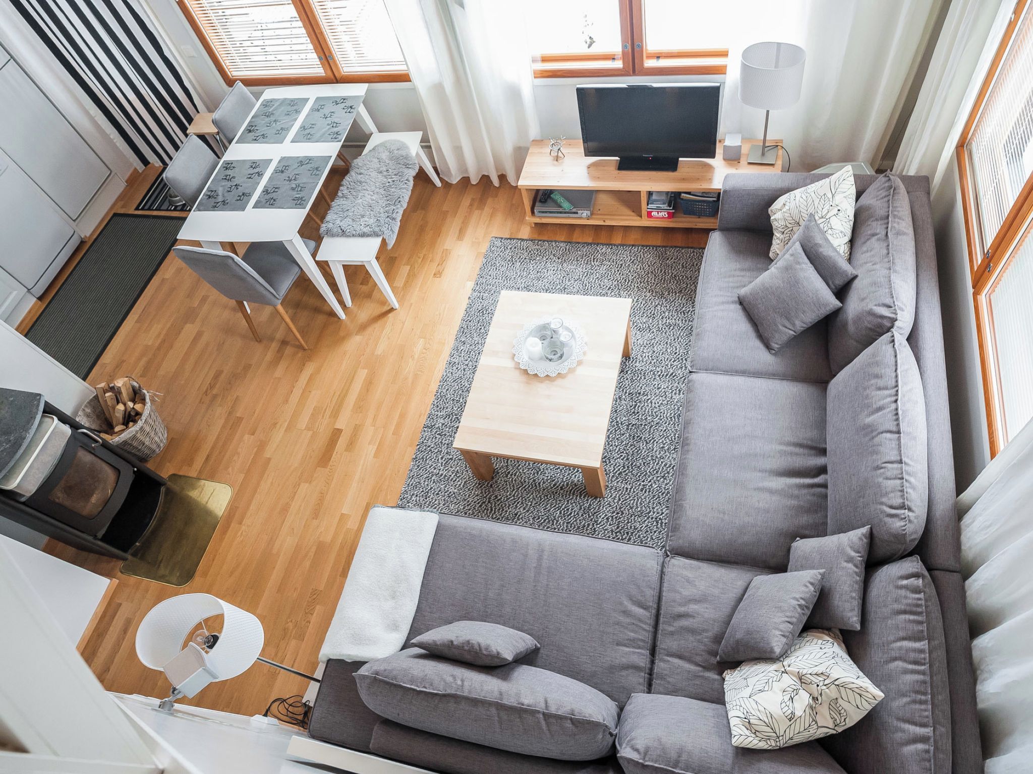 A modern living room with a sofa, coffee table, and a TV.