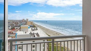 A coastal cityscape with a beach, buildings, and a pier. - Cherry Grove Beach Resort best in SC. (North Myrtle Beach)