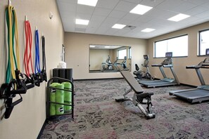 A gym with treadmills, exercise equipment, and a mirror. - Ascent ON Main (PARKER)