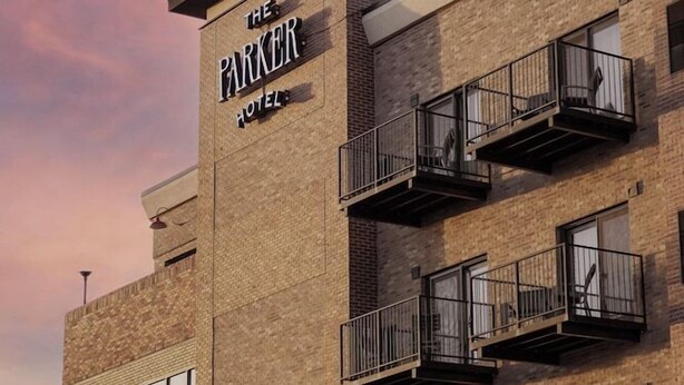 A multi-story hotel with a prominent sign reading "The Parker Hotel." - Ascent ON Main (PARKER)
