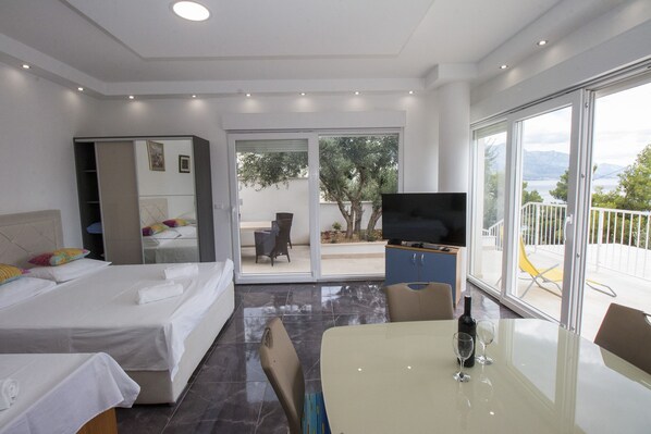 Luxury Studio, Sea View | Living area | Flat-screen TV