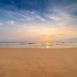 On the beach, white sand, beach umbrellas, beach towels