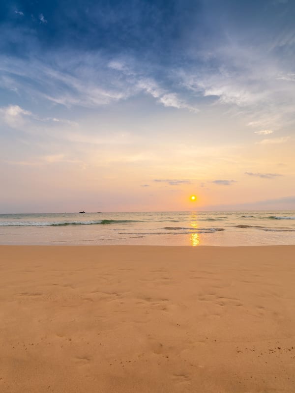 On the beach, white sand, beach umbrellas, beach towels