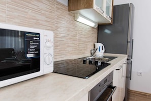 Enjoy cooking with a microwave oven and oven, along with a stainless steel sink and ample storage.