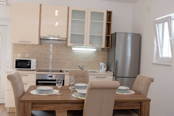 Enjoy meals in the kitchen, where a central island serves as a dining table and stainless steel appliances make cooking easy.