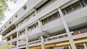 A multi-story building with a flat facade, large windows, and air conditioning units. - Itsy Hotels Auzone & Spa (Chandigarh)