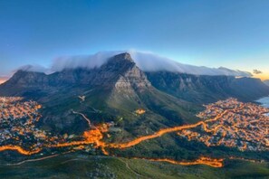 A mountainous landscape with a town at the base, featuring winding roads and a prominent peak.