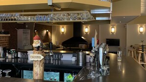 A bar area with a counter, glasses, and a sign reading "CHOUFFE". - Orava Durbuy (Durbuy)