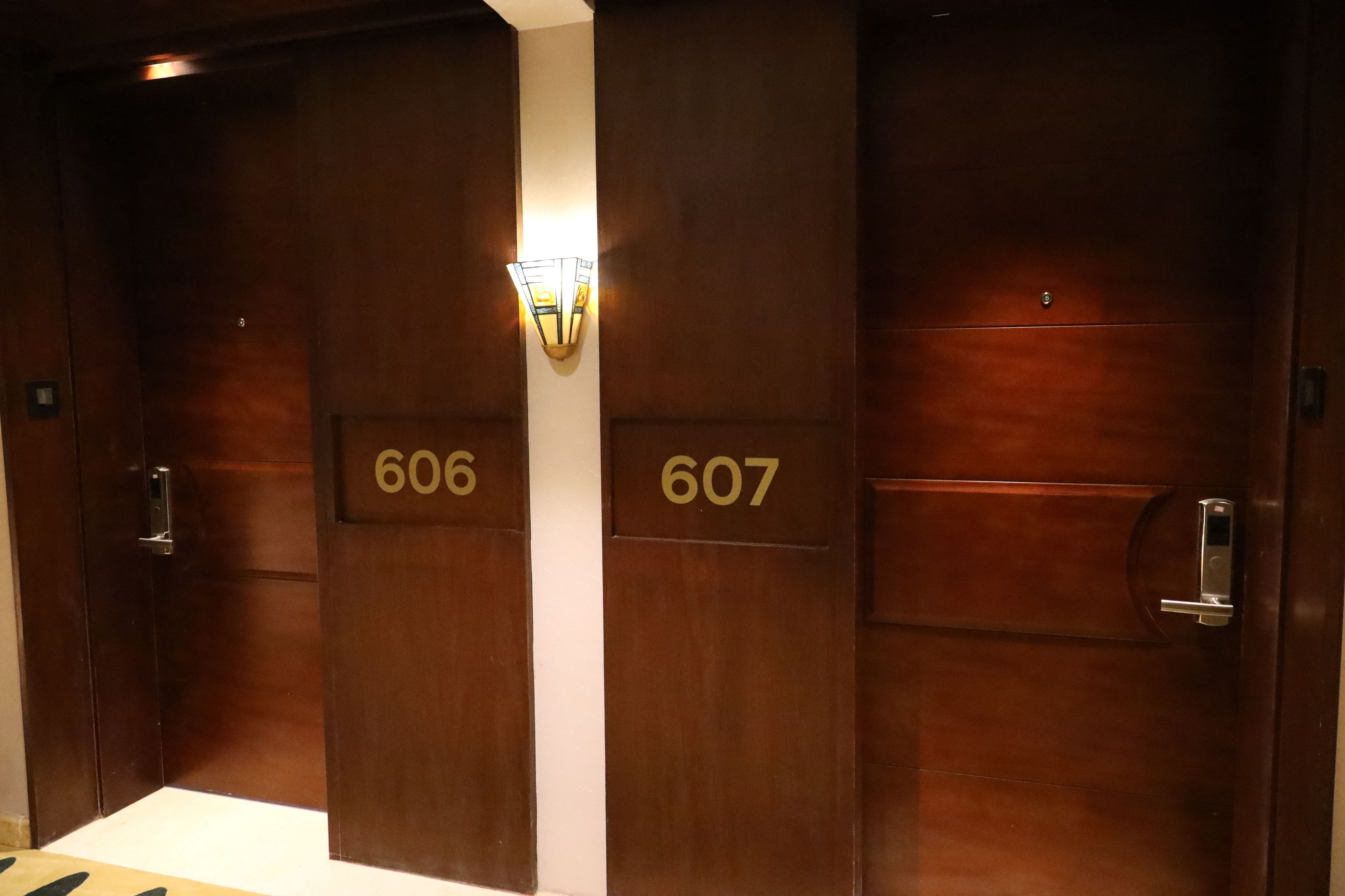 Un juego de puertas de madera dobles con los números 606 y 607, que indican números de habitaciones de hotel.
