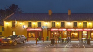 A building with multiple business fronts including a lounge, bar, and accommodation. - Nevins Inn (Newport)