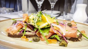 A plate of food with various ingredients. - Nevins Inn (Newport)