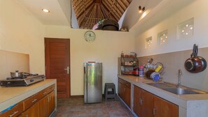 Una cocina compacta con refrigerador, estufa y lavaplatos.
